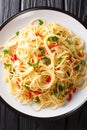 Spaghetti Aglio e OlioÃÂ is a simple Italian dish of garlic, olive oil, parsley close-up in a plate. Vertical top view Royalty Free Stock Photo